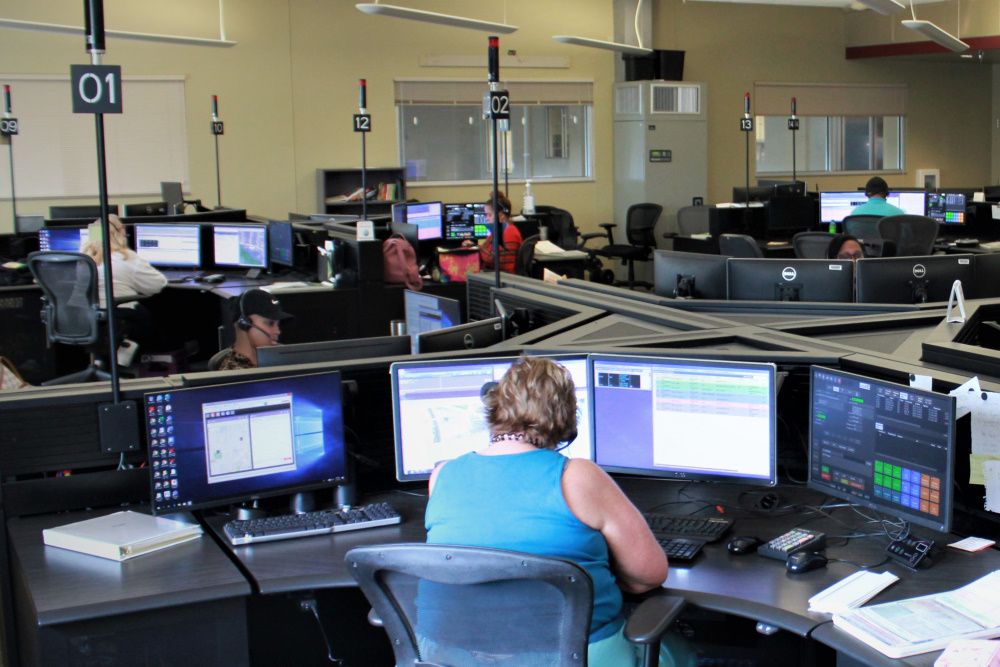 Emergency 911 Operators at call-taking workstations in the ECC