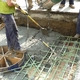 Duke contractor Intrens pours a new manhole lid at the northwest corner of 5th & Walnut