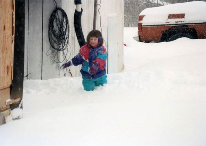Child knee deep in snow